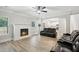 Open-concept living room with a fireplace and hardwood floors at 1511 New Hope Rd, Locust Grove, GA 30248