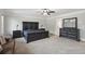 Spacious main bedroom with carpet, ceiling fan, and elegant dark wood furniture at 1511 New Hope Rd, Locust Grove, GA 30248