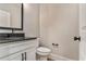 Elegant half bathroom with a stylish vanity, granite countertop and sleek fixtures at 1511 New Hope Rd, Locust Grove, GA 30248
