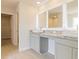 Bathroom featuring dual sinks with granite countertops, lighted mirrors, and access to a walk-in closet at 300 Bianca Way, Mcdonough, GA 30253