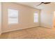 Spacious bedroom with neutral walls, plush carpet, and two windows, offering a serene living space at 300 Bianca Way, Mcdonough, GA 30253