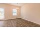 Dining area with hardwood floors, modern chandelier, and backyard access at 300 Bianca Way, Mcdonough, GA 30253