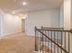 Upstairs hallway with wood-look banister, and view of several bedrooms and linen closet at 300 Bianca Way, Mcdonough, GA 30253