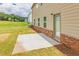 Concrete patio and back door featuring the brick foundation of the home at 300 Bianca Way, Mcdonough, GA 30253