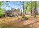 Spacious backyard with mature trees and a patio area perfect for outdoor entertaining at 308 Helena Pl, Mcdonough, GA 30252