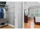 Bedroom closet with open shelving and wood flooring at 308 Helena Pl, Mcdonough, GA 30252