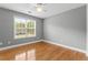 Bedroom with hardwood flooring and natural light through a large window at 308 Helena Pl, Mcdonough, GA 30252