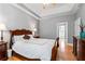 Spacious primary bedroom with wood floors, a tray ceiling, and ample natural light at 308 Helena Pl, Mcdonough, GA 30252