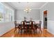 Formal dining room with hardwood floors, wainscoting, and ample natural light at 308 Helena Pl, Mcdonough, GA 30252