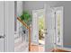 Bright entryway featuring wood floors, staircase, and view to the front porch at 308 Helena Pl, Mcdonough, GA 30252