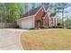 Two-story home with a brick facade, an attached garage, and well-manicured landscaping at 308 Helena Pl, Mcdonough, GA 30252