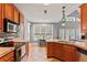 Eat-in kitchen with wooden cabinets, stainless appliances, and tile countertops at 308 Helena Pl, Mcdonough, GA 30252