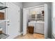 Convenient laundry room with washer, dryer, shelving, and exterior access door at 308 Helena Pl, Mcdonough, GA 30252
