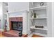 Close-up of the brick fireplace with a white mantle and built-in shelving in the living room at 308 Helena Pl, Mcdonough, GA 30252