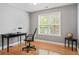 Home office area showcasing desk, chair, and natural light from a window at 308 Helena Pl, Mcdonough, GA 30252