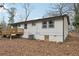 Home's back exterior featuring a cozy deck and well-manicured surroundings at 1700 Shirley Sw St, Atlanta, GA 30310