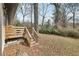 Rear view of a wooden deck and stairs leading to a leaf-covered backyard at 1700 Shirley Sw St, Atlanta, GA 30310