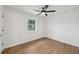 Bedroom showing hardwood floors, a window, and a ceiling fan at 1700 Shirley Sw St, Atlanta, GA 30310