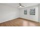 Bright bedroom featuring hardwood floors, a ceiling fan, and two windows offering natural light at 1700 Shirley Sw St, Atlanta, GA 30310