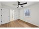 Bedroom features hardwood floors, a window, and a view into the en suite bathroom at 1700 Shirley Sw St, Atlanta, GA 30310