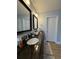 Bathroom vanity with dual sinks, granite counters, dark cabinets, and updated lighting at 3331 Freedom Nw Lndg, Kennesaw, GA 30144