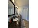 Bathroom featuring a dark granite countertop and dual mirrors at 3331 Freedom Nw Lndg, Kennesaw, GA 30144