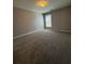 Carpeted bedroom with neutral walls, a ceiling light, and a large window at 3331 Freedom Nw Lndg, Kennesaw, GA 30144