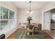 Staged dining area with hardwood floors and a modern table setting at 3331 Freedom Nw Lndg, Kennesaw, GA 30144