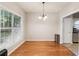 Dining room with hardwood floors, large window, and neutral paint at 3331 Freedom Nw Lndg, Kennesaw, GA 30144