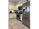 Kitchen with stainless steel appliances, black countertops, and light cabinets at 3331 Freedom Nw Lndg, Kennesaw, GA 30144