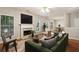 Staged living room with hardwood floors, a fireplace, and a comfortable seating area at 3331 Freedom Nw Lndg, Kennesaw, GA 30144