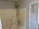 This bathroom features a tub with cream colored tile walls and a mounted shower head at 4227 Sheppard Xing Way, Stone Mountain, GA 30083