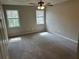 Bedroom with neutral colored walls and carpet and two large windows at 4227 Sheppard Xing Way, Stone Mountain, GA 30083