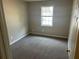 A simple bedroom boasts neutral walls and a window with white blinds at 4227 Sheppard Xing Way, Stone Mountain, GA 30083