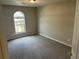 A bright bedroom has soft, neutral walls, carpet and a large window with an arched top at 4227 Sheppard Xing Way, Stone Mountain, GA 30083