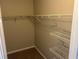 Walk-in closet with wall-mounted shelving to maximize storage space at 4227 Sheppard Xing Way, Stone Mountain, GA 30083