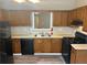 Kitchen with a black refrigerator and dishwasher and a stainless steel sink at 4227 Sheppard Xing Way, Stone Mountain, GA 30083