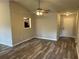 Open-concept living room with ceiling fan and wood flooring at 4227 Sheppard Xing Way, Stone Mountain, GA 30083