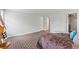 Spacious primary bedroom showcasing brick flooring and access to bathroom at 5130 Forest Hills Ct, Cumming, GA 30041