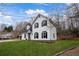 Well-maintained home with black shutters and an expansive green lawn at 5130 Forest Hills Ct, Cumming, GA 30041