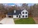 Charming two-story home featuring black shutters, a welcoming entryway and covered parking at 5130 Forest Hills Ct, Cumming, GA 30041