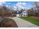 Beautiful home with a long drive, well-manicured lawn, and inviting front porch at 5130 Forest Hills Ct, Cumming, GA 30041