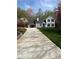 Charming two-story home featuring a manicured lawn, and long driveway at 5130 Forest Hills Ct, Cumming, GA 30041