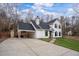 Attractive two-story home featuring black shutters, covered parking and a well-manicured front lawn at 5130 Forest Hills Ct, Cumming, GA 30041