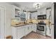 Well-lit kitchen with stainless steel appliances and ample cabinet space at 5130 Forest Hills Ct, Cumming, GA 30041