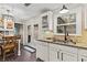 Bright kitchen with brick floors, granite countertops, and white cabinets and appliances at 5130 Forest Hills Ct, Cumming, GA 30041