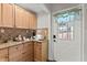 Kitchenette features light wood cabinets, granite counters, and tiled backsplash at 5130 Forest Hills Ct, Cumming, GA 30041