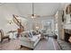 Comfortable living room area with a fireplace, staircase, and ample natural light at 5130 Forest Hills Ct, Cumming, GA 30041