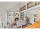 Open living room featuring built-in bookshelves, brick floors, and a cozy fireplace at 5130 Forest Hills Ct, Cumming, GA 30041