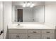 Bright bathroom vanity features a white countertop, classic fixtures, and a large mirror at 1213 Fairwinds Dr, Loganville, GA 30052